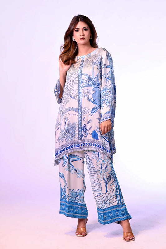 Woman wearing a blue and white patterned outfit on a white background