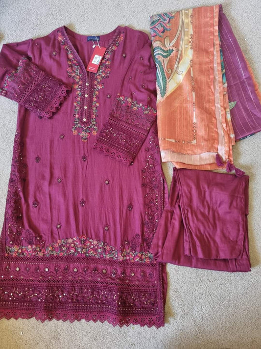 Purple embroidered outfit with matching pants and a pink dupatta on a neutral background